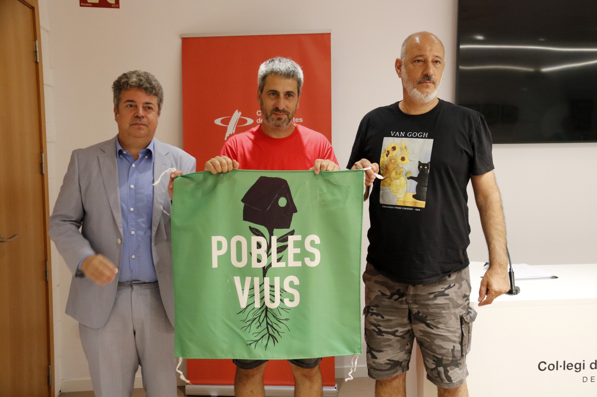 L'adovcat Albert Calduch, el membre de Pobles Vius Gerard Batalla i l'alcalde de Tornabous, Bernat Vilaró, mostren una pancarta de Pobles Vius